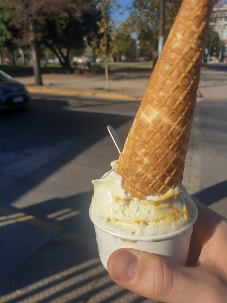 White Chocolate Maracuja and Lemon Mint Sorbet in a small bucket with an ice cream cone on top.