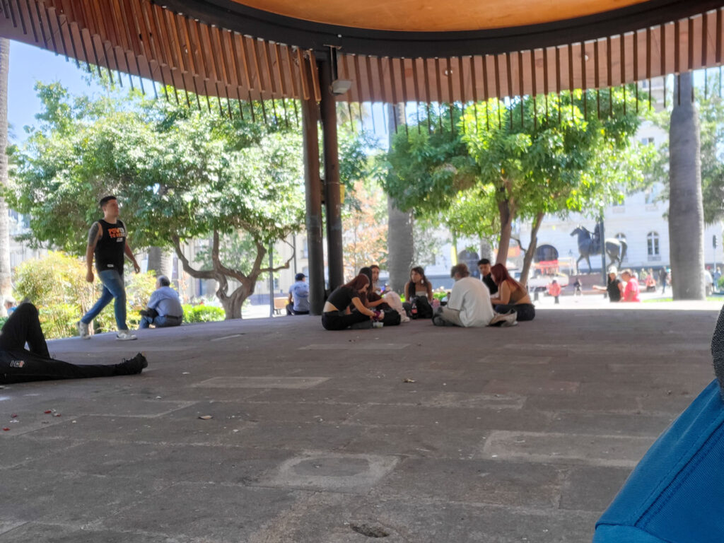 Young people chilling in the pavillon on the plaza del armas de Santiago de Chile.
