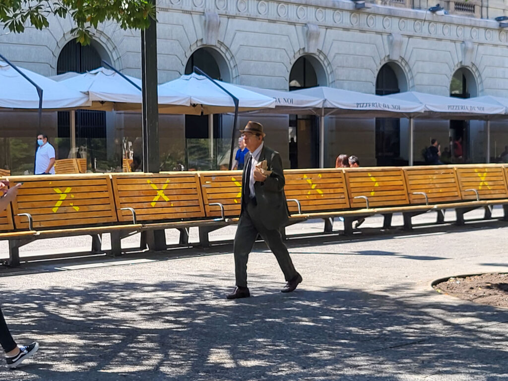 A man walking on the plaza del armas in santiago de chile.